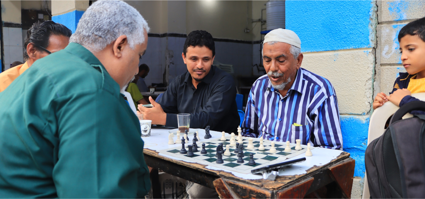 Crater District's chief of police playing chess with a citizen during a 